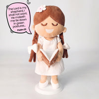 BibleGirl is the adorable plush girl doll that speaks 36 Bible verses.  Holds her Bible with magnets in her hands and in the Bible.  Wholesome dress.  Beautiful braids with bows and a flower in her hair.  Perfect Christmas  gift idea for Christian girls.  From Jesusdoll.com.