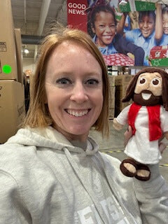 Workers at the Operation Christmas Child Processing Center in Boone, NC.  are packing The Shoebox Jesus Doll into shoeboxes to be distributed to children around the world. 